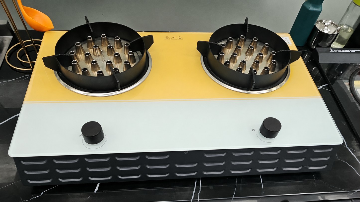 Two gas burners on a yellow and gray base with a black knob each.