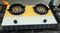 Two gas burners on a yellow and gray base with a black knob each.